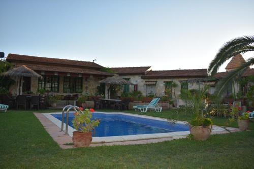 a house with a swimming pool in the yard at Le petit Olivier 