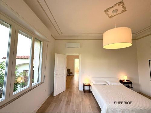 a bedroom with a bed and a large window at AMALIA Villa & Apartments in Lucca