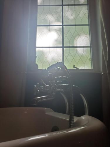 a bathroom with a sink and a window at Le Manoir aux Secrets in Rawdon