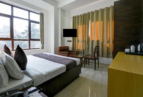 Postel nebo postele na pokoji v ubytování FabHotel Prime The Rivlet MG Road