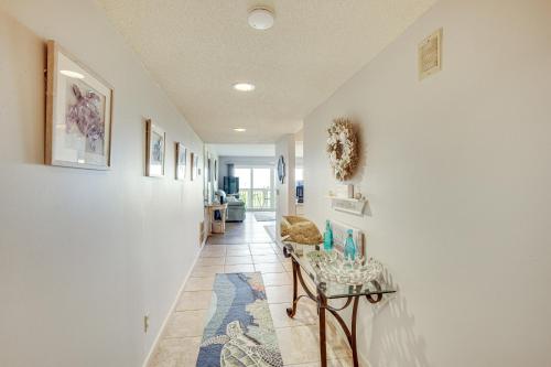 a hallway with white walls and a blue rug at St Helena Island Condo - half Mi to Beach in Oceanmarsh Subdivision