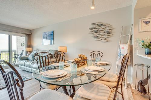 a dining room with a glass table and chairs at St Helena Island Condo - half Mi to Beach in Oceanmarsh Subdivision