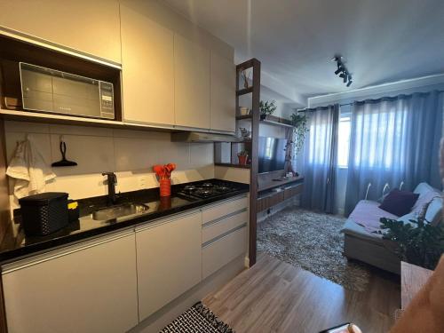 a kitchen with a sink and a stove at Apartamento ao lado Vibra, transamérica, Tóquio marine e Morumbis in Sao Paulo