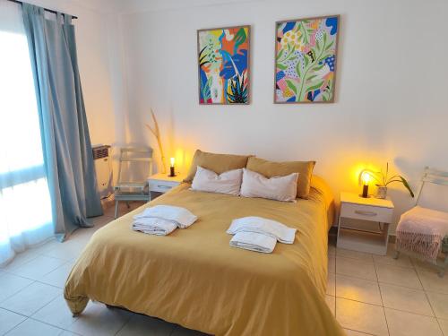 a bedroom with a bed with two towels on it at Estación Velez Cipolletti in Cipolletti