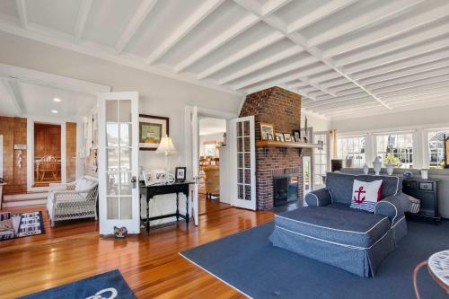 a living room with a couch and a fireplace at Waterfront Walk to Beach in Barnstable