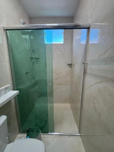 a shower with a glass door in a bathroom at Morada Manaus in Manaus