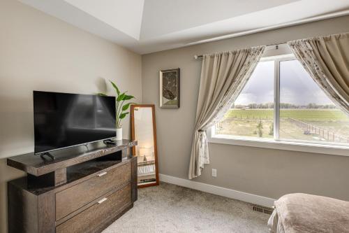 a bedroom with a flat screen tv and a window at 4 Mi to Snake River Family Home with Yard in Rigby in Rigby