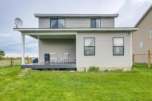 a house with a deck with two chairs on it at 4 Mi to Snake River Family Home with Yard in Rigby in Rigby
