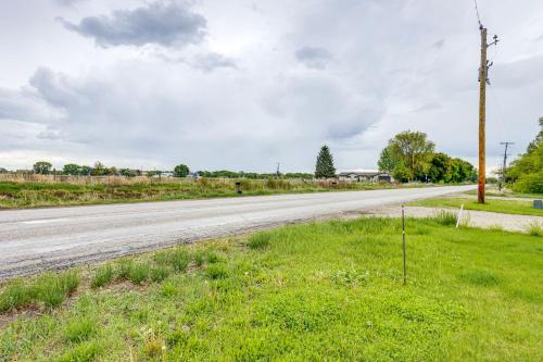 an empty road with a pole in the grass at 4 Mi to Snake River Family Home with Yard in Rigby in Rigby