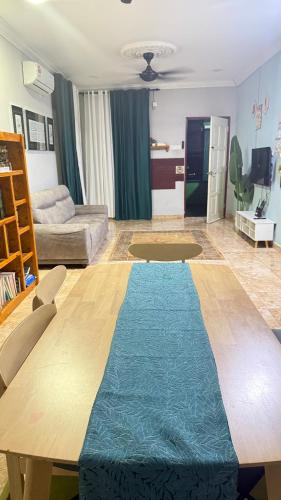 a living room with a wooden table and a couch at Mk homestay butterworth in Butterworth