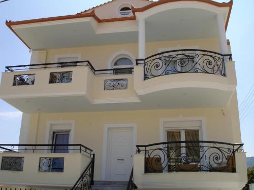 a large house with balconies on the side of it at Prime Luxury Villa beach front in Nea Vrasna