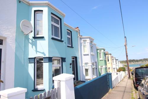 a row of houses on a street with a fence at Padstow townhouse, close to harbour in Padstow