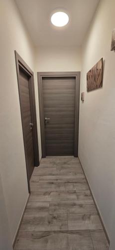 a hallway with two doors and a tile floor at SLEEP & GO Pisa in Pisa