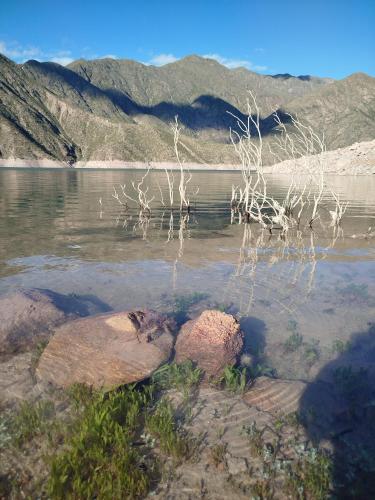 a body of water with some rocks in the water at Complejo de Cabañas Tierra de Luna in Potrerillos