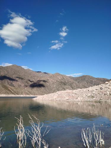 a body of water in the middle of a desert at Complejo de Cabañas Tierra de Luna in Potrerillos