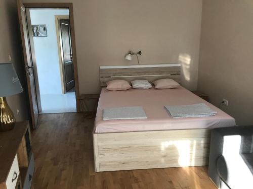 a small bedroom with a bed with pink sheets at Holiday house Anna in Veli Iž