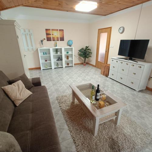 a living room with a couch and a coffee table at Villa Mátis in Balatonederics