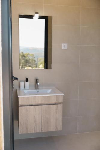 a bathroom with a sink and a window at Casa do Tojo (Camélias de Basto - Turismo Rural) in Pedras Alvas