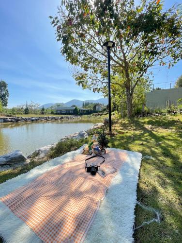 a picnic table on a path next to a river at Lake paradise villa khaoyai LB4 in Ban Rai Khlong Sai