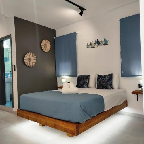 a bedroom with a large bed with blue sheets and pillows at Flisvos Seaside Apartments in Lygia