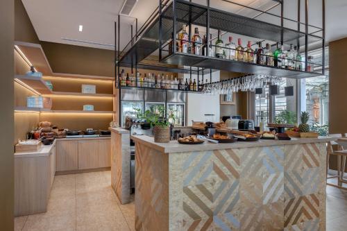 a restaurant with a bar with food and drinks at Casual Kubic Athens in Athens
