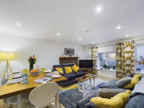 a living room with a couch and a table at Joiners cottage in Penrith