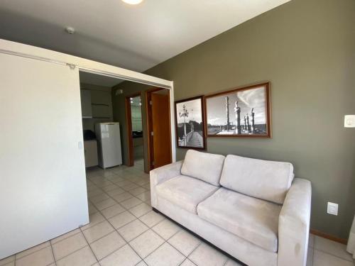 a living room with a white couch in a room at Flat no Condomínio Metrópolis - Ilha do Leite in Recife