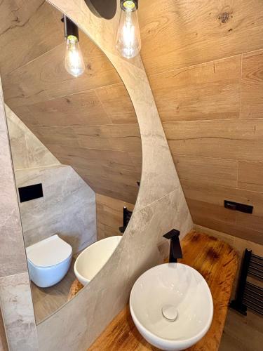 a bathroom with two sinks and a toilet at Zakątek Zakopane in Zakopane