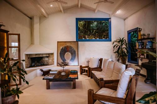 a living room with a couch and a fireplace at Pousada Picinguaba in Ubatuba