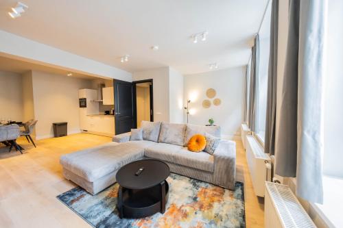 a living room with a couch and a table at Alphabet Apartments - Jufferstraat 10 in Rotterdam