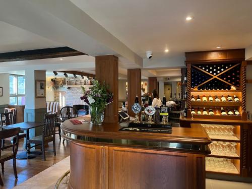 a bar in a restaurant with wine bottles at The Angel Inn in Thirsk