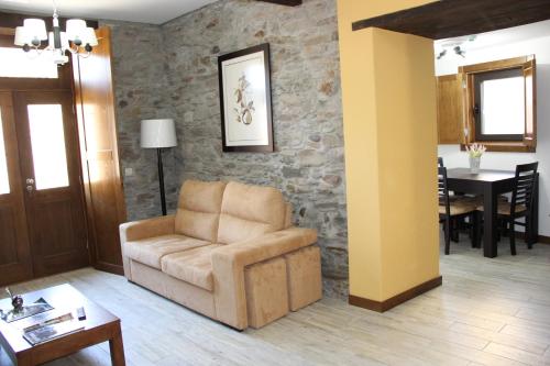 a living room with a chair and a table at Casa do Ferrador in São Pedro de Vale do Conde