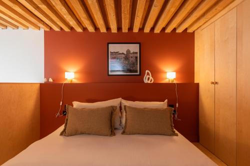 a bedroom with a large bed with two lamps at SmartStay Traboule - Place Bellecour in Lyon