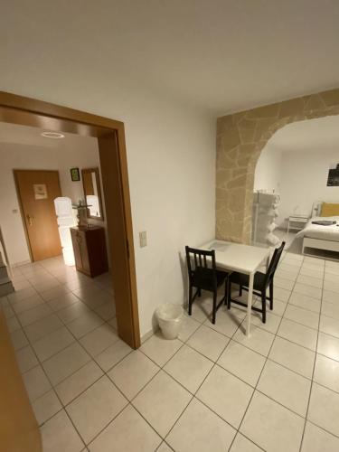 a kitchen and dining room with a table and chairs at Kirchberg Comfort Rooms in Luxembourg