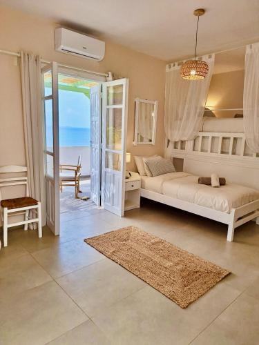 a bedroom with a bed and a view of the ocean at Kathys Island Retreat in Adia