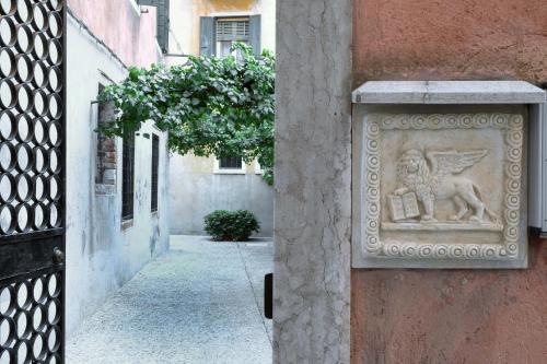 a stone statue on the side of a building at la levantina in Venice
