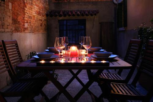 a table with glasses and plates and lights on it at la levantina in Venice