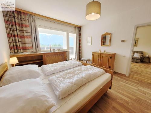Un dormitorio con dos camas y una gran ventana. en Apartment Svea by FiS - Fun in Styria, en Bad Mitterndorf