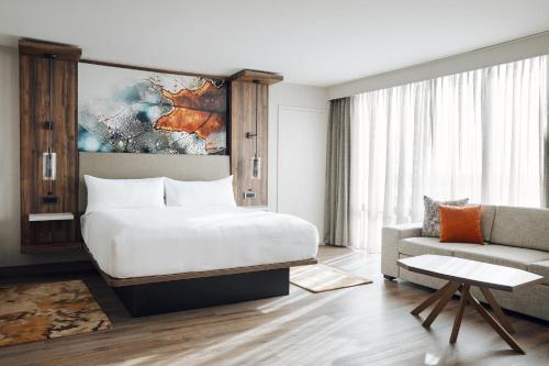 a hotel room with a bed and a couch at Chicago Marriott Oak Brook in Oak Brook