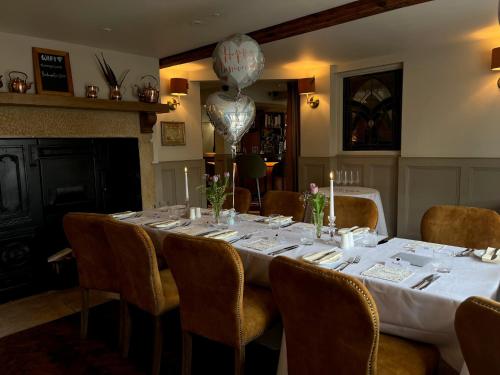 a dining room with a long table with chairs and a balloon at The Angel Inn in Thirsk