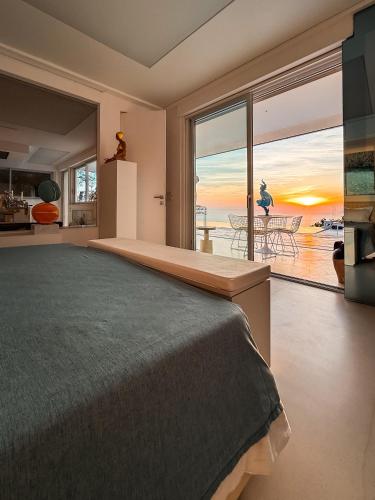 a bedroom with a bed and a view of the ocean at Chalet Azzurro Capri in Anacapri