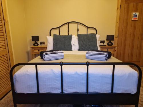 a bed with blue and white sheets and pillows at Failte Stay in Inverness
