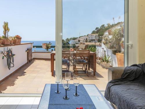 a living room with a table and glasses on a balcony at Apartment Cala Salionc by Interhome in Cañet de Mar