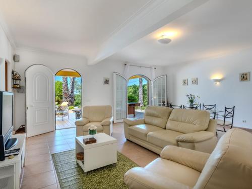 a living room with two couches and a tv at Villa Villa Monte da Torre by Interhome in Loulé