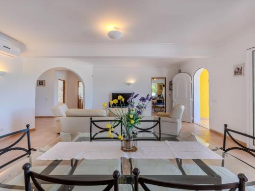 a living room with a table with flowers on it at Villa Villa Monte da Torre by Interhome in Loulé