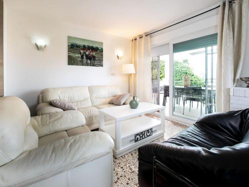 a living room with a couch and a table at Holiday Home Delfines by Interhome in Benajarafe