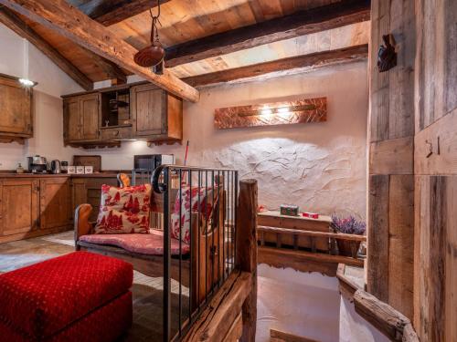 a living room with a red couch and wooden walls at Apartment Baita Baulin-1 by Interhome in Baulen