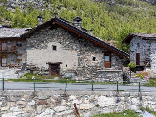 a stone building on the side of a road at Apartment Baita Baulin-1 by Interhome in Baulen