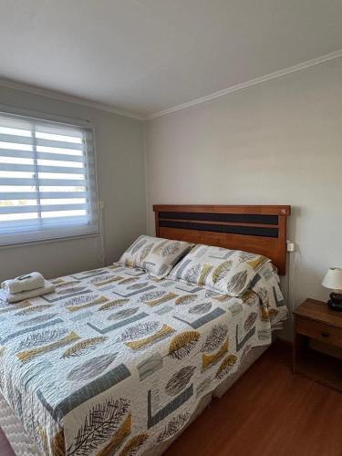 a bedroom with a bed with a quilt on it at Hostal Mi Casa in Canela Baja