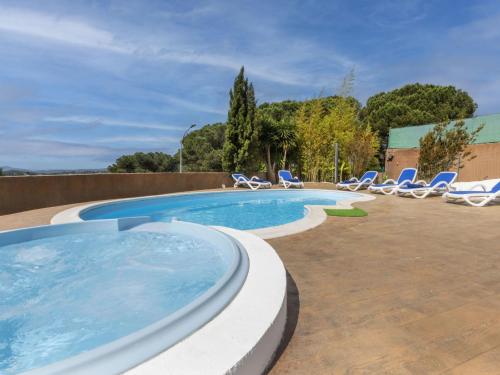 a swimming pool with lounge chairs and a swimming pool at Holiday Home Mercury by Interhome in Lloret de Mar